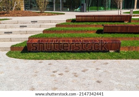 New modern bench in park. Outdoor city architecture, wooden benches, outdoor chair, urban public furniture, empty plank seat, comfortable bench in recreation area Royalty-Free Stock Photo #2147342441