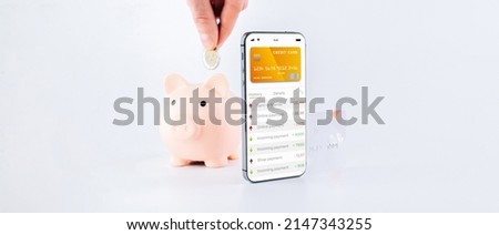 E banking concept. Mobile phone with internet online bank app. Pig bank with credit card on white background. Online wallet save money