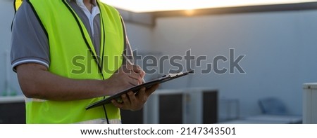 Factory engineers walking and checking the cooling system of the factory. Fore man records the condition of the compressor before maintenance according maintenance plan.

 Royalty-Free Stock Photo #2147343501