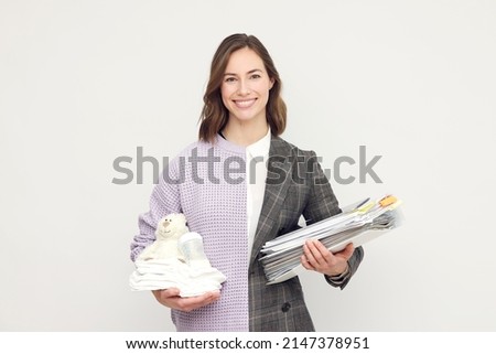 Half mother and half business woman with paperwork in the other hand. Concept: The balance of family life and business life or career. Lifestyle.