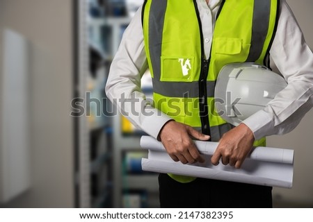 Asian worker man working in safety work wear helmet in factory workshop industry machine professional.