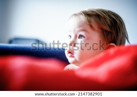 Funny cute baby. Beautiful girl with blond hair. Portrait of a happy child. Carefree childhood.