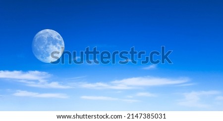 beautiful background and lunar panorama of blue sky with white clouds an a full moon 