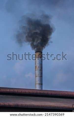 Factory flue emit smoke, pollution, industry that negatively affects the environment Royalty-Free Stock Photo #2147390369