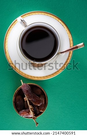 cup of hot tea and date dry fruit