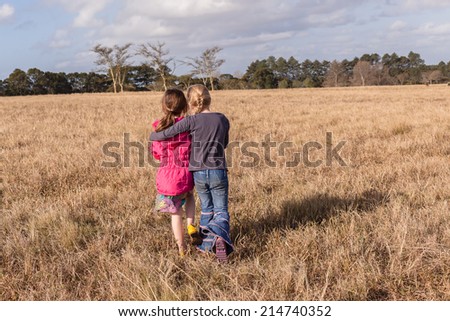 Girls Walking Away Caring Wilderness Young girl walking away caring hugs helps scared friend back to camping site in rural wilderness countryside