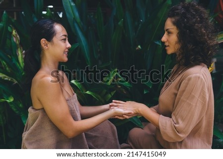 Female psychiatrist's hands holding hands of patient together spending weekend daytime for meditation therapy and holistic retreat healing, diverse women communicate about trust and support Royalty-Free Stock Photo #2147415049