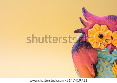 Close-up of part of a colorful metallic owl with copy space