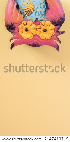 Funny metallic owl on yellow background with copy space