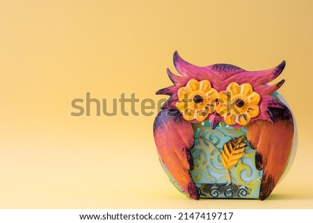 Colorful decorative metal owl with copy space.