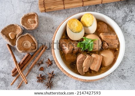 Top view stewed eggs and pork belly in black sweet sauce, traditional and popular Thai food Royalty-Free Stock Photo #2147427593
