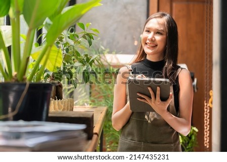asian female adult creative designer happiness thinking work and reserach and make note of interesting ideas via tablet device,asian woman wokring casual relax at her home studio with window garden