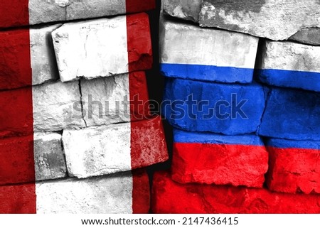 Concept of the relationship between Peru and Russia with two painted flags on a damaged brick wall