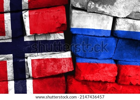 Concept of the relationship between Norway and Russia with two painted flags on a damaged brick wall