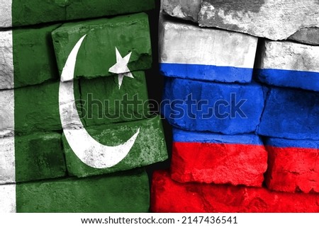 Concept of the relationship between Pakistan and Russia with two painted flags on a damaged brick wall