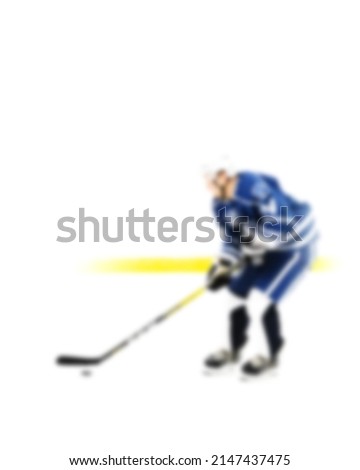 Hockey player in blue uniform in motion on the ice - out of focus hockey player on ice - blur hockey match on background