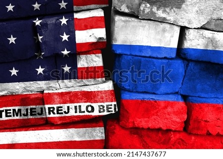 Concept of the relationship between Bikini Atoll and Russia with two painted flags on a damaged brick wall