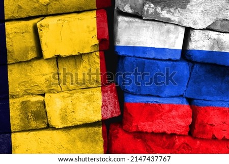 Concept of the relationship between Chad and Russia with two painted flags on a damaged brick wall