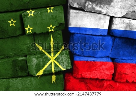 Concept of the relationship between Adygea and Russia with two painted flags on a damaged brick wall