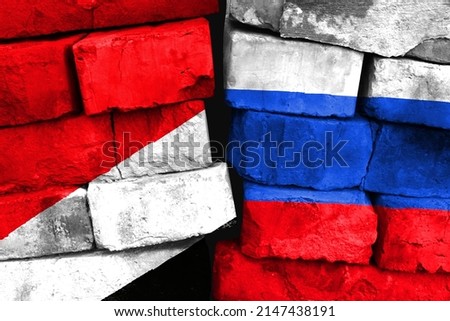 Concept of the relationship between Sealand,Principality of and Russia with two painted flags on a damaged brick wall