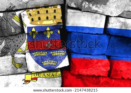 Concept of the relationship between Saint Barthelemy and Russia with two painted flags on a damaged brick wall