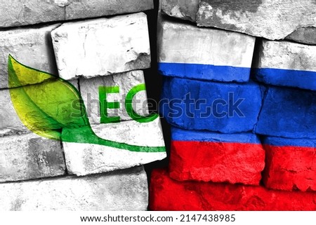 Concept of the relationship between Green ecological healthy food logo and Russia with two painted flags on a damaged brick wall