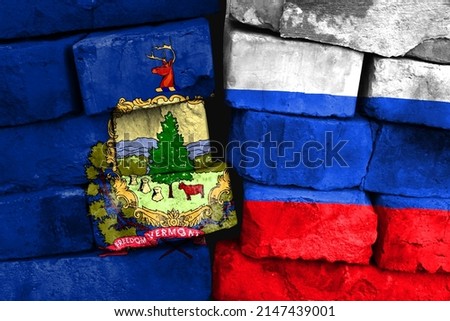 Concept of the relationship between State of Vermont and Russia with two painted flags on a damaged brick wall