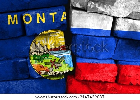 Concept of the relationship between State of Montana and Russia with two painted flags on a damaged brick wall