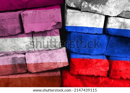 Concept of the relationship between Lesbian pride and Russia with two painted flags on a damaged brick wall