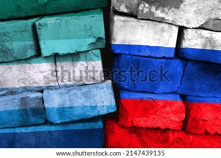 Concept of the relationship between Gay man and Russia with two painted flags on a damaged brick wall