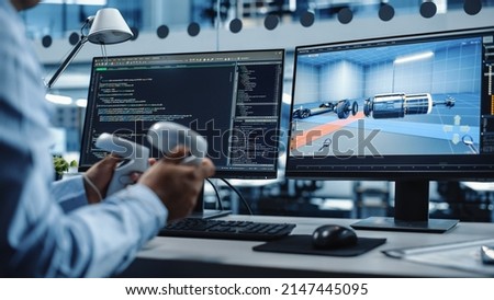 Industrial Software Developer Writing Code and Testing Automotive Manufacturing Interface. Engineer Editing Electric Motor and Car Chassis while Wearing Virtual Reality Headset and Using Controllers.