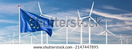 Official flag of the European Union in front of a large windpark with wind turbines Royalty-Free Stock Photo #2147447895