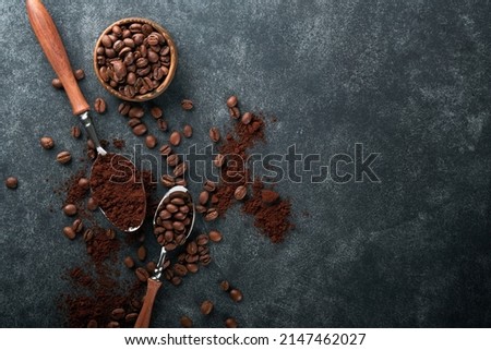 Coffee beans background. Roasted coffee concept with differents types of beans and cinnamon sticks on dark black stone background. Top view. Coffee concept. Mock up.