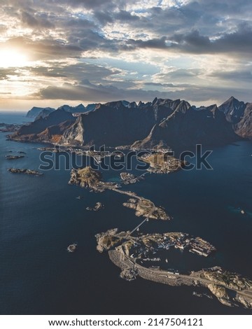 areal picture of Reine, a little place in Lofoten in Norway. It has a lot of small islands lika a island paradise with a road that jumps from one island to the other. Big beautiful mountains and sun 