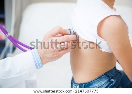Pediatrician examining little child with stethoscope. Medical examination of little girl. Professional clinical diagnostics. Close-up doctor hand with stethoscope. Health check in pediatric office. Royalty-Free Stock Photo #2147507773