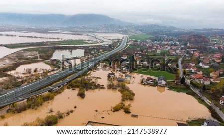Aerial drone view of torrential rain causes flash floods in residential areas. Houses and roads surrounded by water. Climate change. Heavy rainfall consequences. 
 Royalty-Free Stock Photo #2147538977