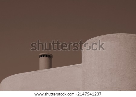 Photography of contemporary  modern construction with minimal and geometric architecture shapes. Building volume fragment walls, clean and fluid lines forms. Monochromatic earth tones palette colors.