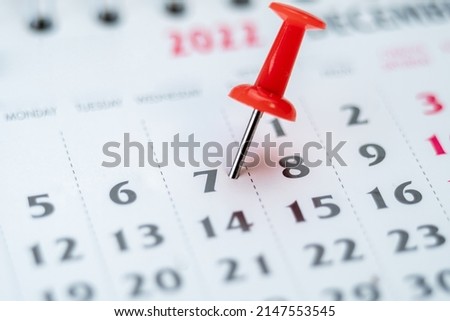 Red push pin on calendar 7th day of the month, mark the Event day with a Pin. Pin on calendar day seven, date number 7. Seventh day of the month is marked with a red thumbtack Royalty-Free Stock Photo #2147553545