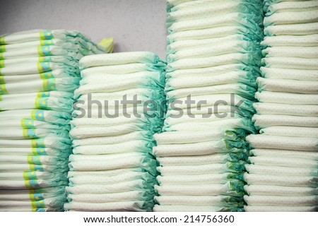 Diapers stacked in a piles in the child room. Royalty-Free Stock Photo #214756360