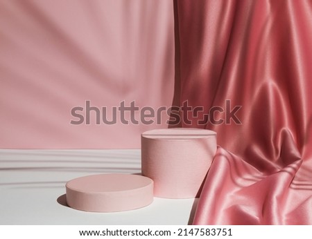 Pastel pink composition with satin curtain and palm leaf shadow. Suitable for Product Display and Business Concept. Modern aesthetic.