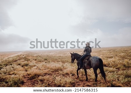 Woman riding on a horse during sunrise. 
