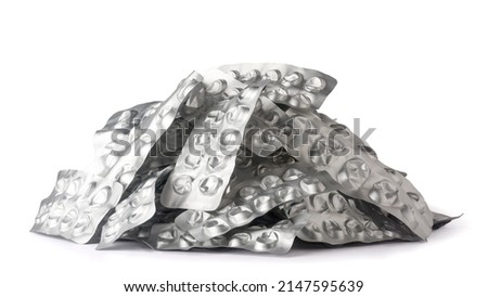 pile of used empty pill blister packs, silver medicine packs isolated on white background, treatment and medication concept Royalty-Free Stock Photo #2147595639