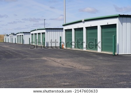 Green door storage units for the community to use. Royalty-Free Stock Photo #2147603633