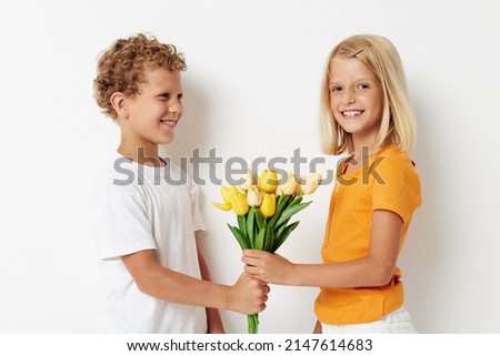Small children fun birthday gift surprise bouquet of flowers isolated background unaltered