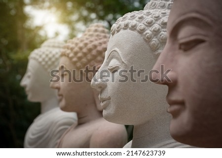 Selective focus image of laughing buddha with abstract and bokeh lights peaceful meditation buddha statue with natural stone carving background image of laughing buddha face of a smiling buddha statue