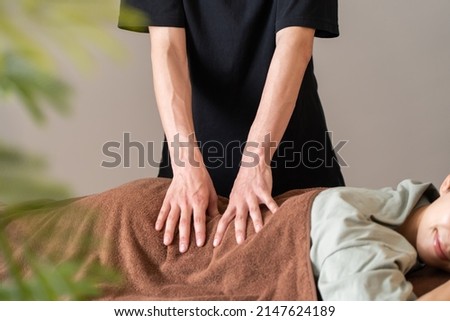 Asian man doing a massage Royalty-Free Stock Photo #2147624189