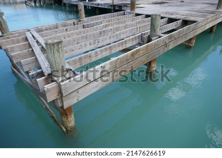 Unfinished wooden boat dock over ocean water Royalty-Free Stock Photo #2147626619