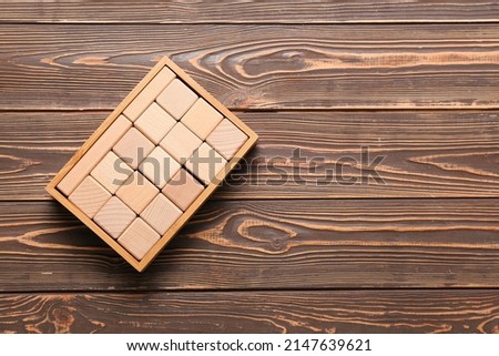 Cubes on dark wooden background
