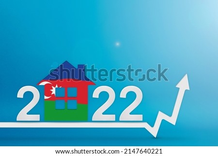 The cost of real estate in Azerbaijan in 2022. Rising cost of construction, insurance, rent in Azerbaijan. House model painted in the colors of the flag, up arrow on a blue background