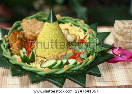 Nasi Tumpeng for celebration, Indonesian cuisine. Yellow rice Royalty-Free Stock Photo #2147641367